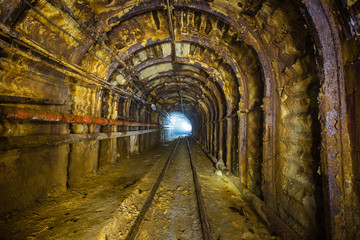 Fototapeta na wymiar Underground gold ore emerald mine shaft tunnel gallery passage with light