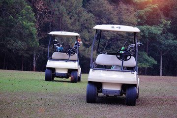 Golfcar in beautiful golf course in the evening golf course with sunshine