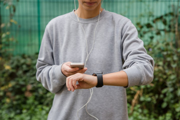 Young woman using wearable tech during fitness workout