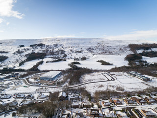 Aerial view of a small Welsh village called Nantyglo in South Wales with community and council housing  covered in snow at winter