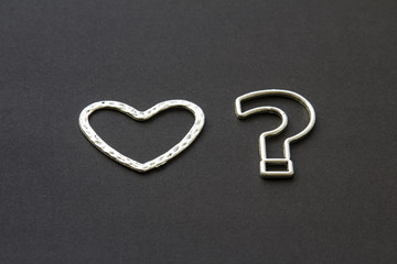  question mark and heart on a black background .likes or dislikes concept