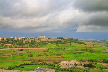 Fototapeta na wymiar The photo was taken from the wall of the ancient city of Mdina in Malta. The picture shows the thunderstorm rallied over the valley lying at the foot of the city.