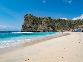 Big rocks in the ocean with white sand at Atuh beach on Nusa Penida island, Indonesia. November, 2018