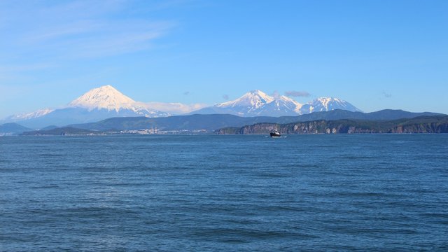 Avachinsky and Koryaksky volcanoes towers over the city of Petropavlovsk-Kamchatsky on the Kamchatka Peninsula, Russia.