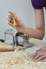 The housewife has prepared home-made noodles in the house. Prepared with eggs and lots of flour.