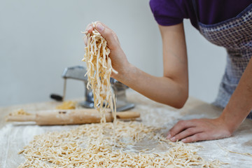 The housewife has prepared home-made noodles in the house. Prepared with eggs and lots of flour.