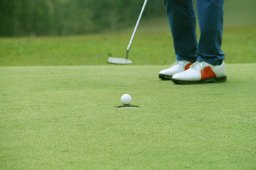 Blurred golfers are patting golf in the evening golf course in Thailand