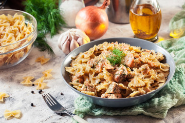 Creamy farfalle pasta with salmon, parmesan cheese and dill