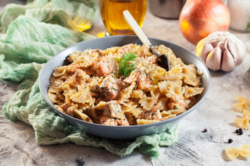 Creamy farfalle pasta with salmon, parmesan cheese and dill