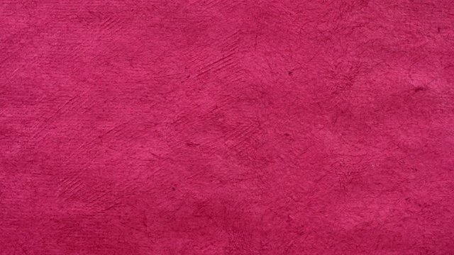 background of pink (rosa) handmade Huun paper created by Mayan artisans in Mexico from a tree bark - horizontal pan