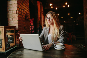 Young business woman working in cafe