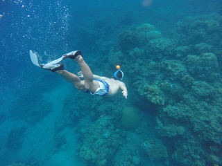 Naklejka na ściany i meble Snorkeling and underwater man