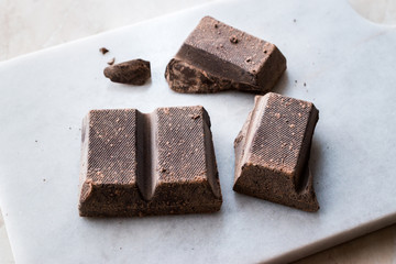 Couverture Bitter Chocolate Pieces on Dark Wooden Surface.