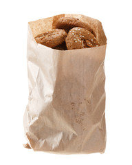 Oatmeal cookies in a paper bag made from kraft paper. Isolated on white background.