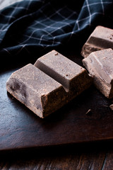 Couverture Bitter Chocolate Pieces on Dark Wooden Surface.
