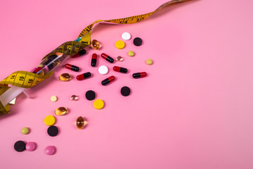 Drugs. Pills. tablet on pink background, medicine and drug concept. Diet. Dietology. pills on a colored background with space for text. concept of losing weight, diet, fat burning, healthy eating.