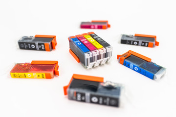 Close-up shot of a CMYK ink cartridges for a color printer isolated on a white background.
