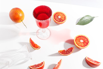 Composition of Sicilian oranges, whole and cut on a white background.