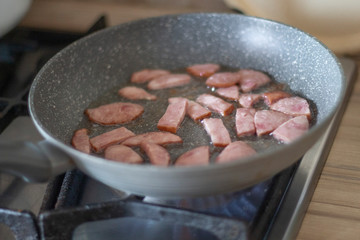 smoked sausage fried in a pan