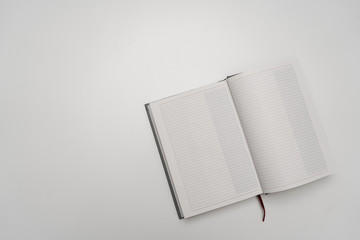 Blank open notebook on white background