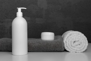 Obraz na płótnie Canvas Spa set with towels and cosmetic bottles on white background