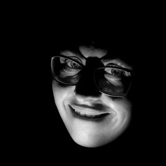 Stylish portrait of attractive caucasian woman in glasses. Black and white shot, low-key lighting....