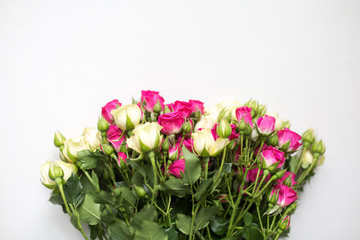 Naklejka na ściany i meble Pink and white rose bush collected in a bouquet. Beautiful floristry for weddings, holidays. Floral decoration of flowers on a light background. Copy space and top view.