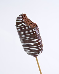 Chocolate cake pop on vintage spoon on light background