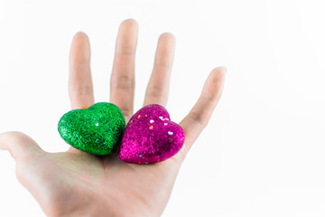 Hand holding mini hearts on white background, valentine day concept.
