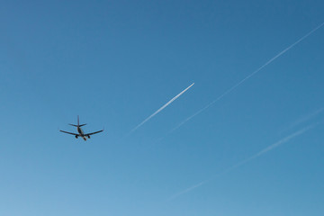 Flying passenger plane on blue sky background