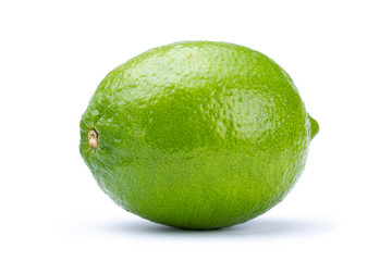 Whole fresh green lime isolated on white background. Citrus and tropical fruits