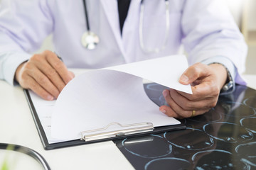 The doctor performs working writing on paperwork and analysis of the disease and the results of the patient's treatment, Healthcare and medical concept.