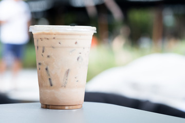 Iced coffee in a plastic glass on a table