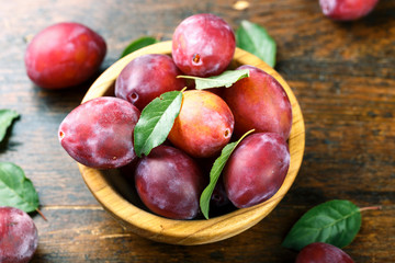 Fototapeta na wymiar ripe plums on wooden background