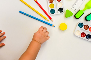 watercolor paints and stationery on white background 