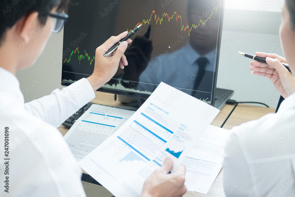 Poster team investment entrepreneur discussing and analysis forex trading charts and graphs on computer scr