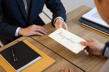 businessman hand sending a resignation letter to executive boss dismissed worker quit out from...