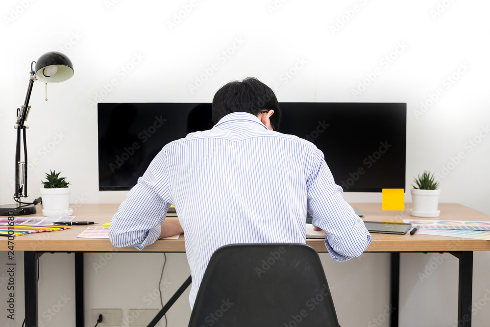 Aufkleber designer editor at work drawing sketches a new project on graphic tablet and color palette sitting a
