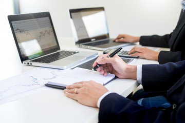 Business Team trader or broker Investment Entrepreneur colleagues working discussing and analysis graph stock market trading with forex chart data, financial, selling and buying concept