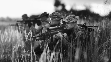 Rangers shooting with his weapon, rifle at sunset. War, army, military concept.