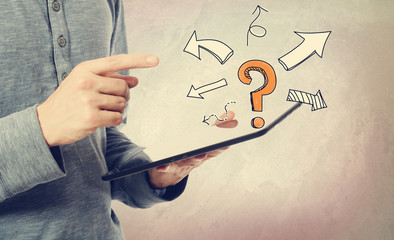 Question mark with arrows with man holding a tablet computer