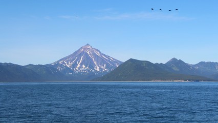 View of Vilyuchinsky volcano (also called Vilyuchik) from tourist boat. It's a stratovolcano in the southern part of Kamchatka Peninsula, Russia.