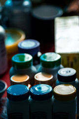 Caps of medicine bottles backlit selective focus