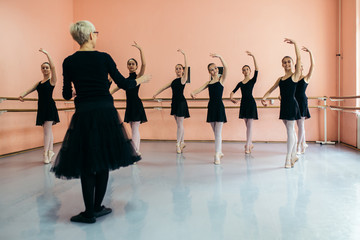 Fototapeta premium The group of beautiful teenage girls practicing ballet dance.