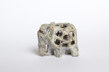elephant, a souvenir of carved stone, on a white gray background