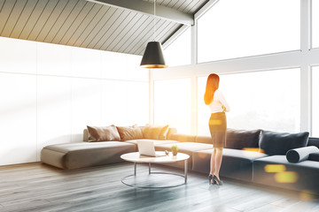 Woman in gray attic living room corner