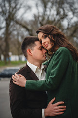 Close up of happy romantic attractive young couple hugging at the street