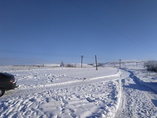 Fototapeta na wymiar winter landscape with road and blue sky