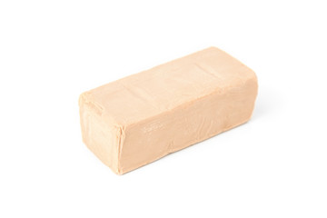 Pressed yeast isolated on white background.