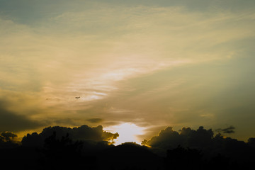 An airplane passing by at sunset 